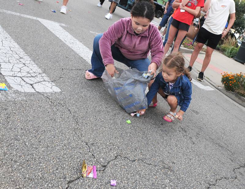 Children scramble for candy treats tossed their way Wednesday evening during Ottawa High’s  annual Homecoming Parade.