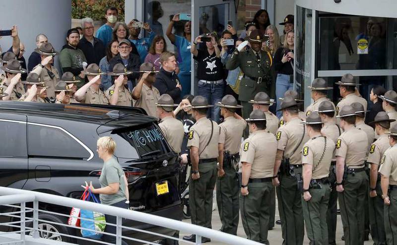Illinois State Police troopers salute Trooper Brian Frank Saturday as he leaves Northwestern Medicine Marianjoy Rehabilitation Hospital in Wheaton for his Lemont home.