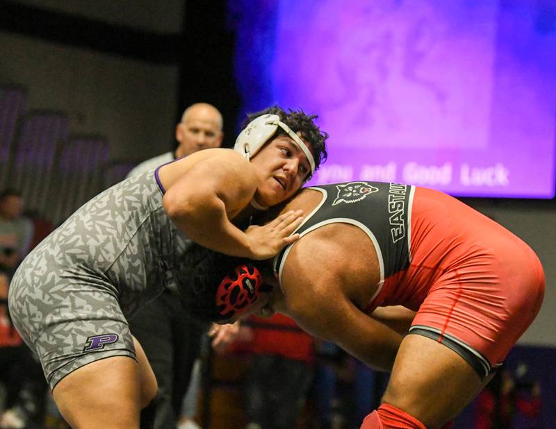 Plano wrestler Elyas Peray takes on an East Aurora wrestler during the 220 weight class championship match where he took 2nd place at the Plano Reaper wrestling classic held a Plano High School.