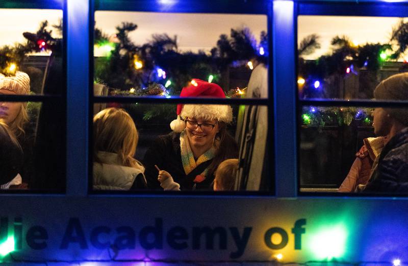 Natalie Deicke talks to others while staying warm in the Kiddie Academy of St. Charles float before the Holiday Homecoming Electric Christmas Parade in St. Charles on Saturday, Nov. 30, 2024.