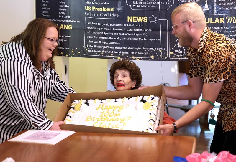 Claire Hubele, a resident at Heritage Woods of DeKalb, can barely see over her birthday cake Wednesday, July 9, 2025, during a party at the facility celebrating her 100th birthday.