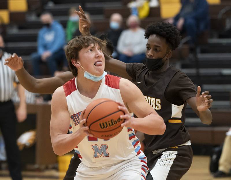 Marian Central's Christian Bentancur is defended by Jacobs' Amari Owens during their game at the Hinkle Holiday Classic basketball tournament on Thursday, December 23, 2021 at Jacobs High School in Algonquin. Ryan Rayburn for Shaw Local