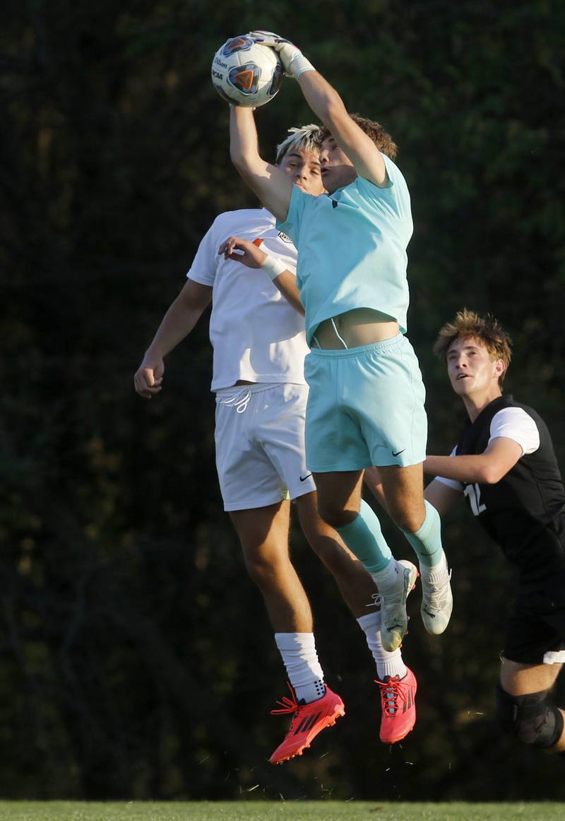 Crystal Lake Central's Anthony Bellino grabs a shot on goal in front of his teammate, Alvaro Manzano,and Prairie Ridge's Samuel Kirk during a Fox Valley Conference soccer match on Thursday, Oct. 10, 2024, at Prairie Ridge High School.