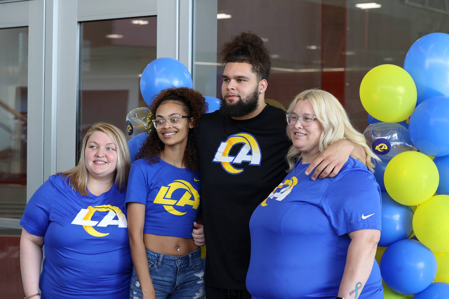 Keagen Trost, a 2019 Kankakee High School grad, takes a photo with his family during a celebration held for him at the school on May 4, 2026, following him being drafted into the NFL to the Los Angeles Rams. Pictured is him mom, Shannon Trost, right, and sisters Brianna, left, and Mariah Trost.