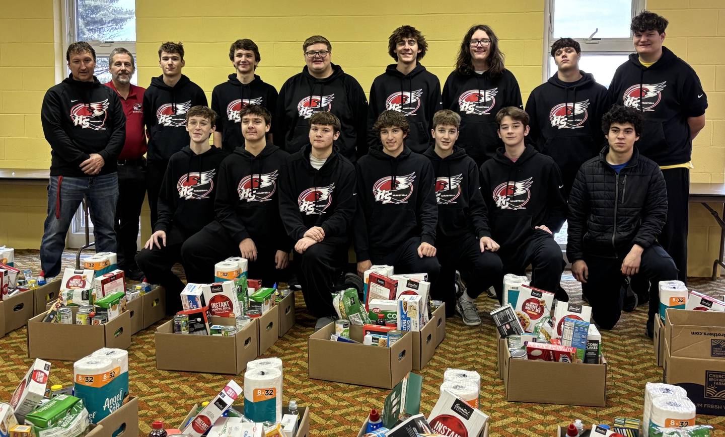 Members of the Henry-Senachwine boys basketball team pose for a photo after volunteering in December with the Red Stocking Fund, which collects food and toys for families in need.