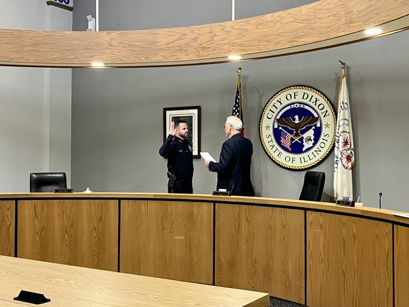 Dixon Mayor Glen Hughes (right) administers the oath of office for Dixon's new chief of police Ryan Bivins (left) at the Dixon City Council meeting Monday, June 2, 2025.