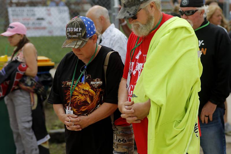 Beth and Robert Severson of Hampshire pray during the Trump Now-Save the American Dream Rally at the McHenry County Fairgrounds on Sunday Aug. 18, 2024, in Woodstock.
