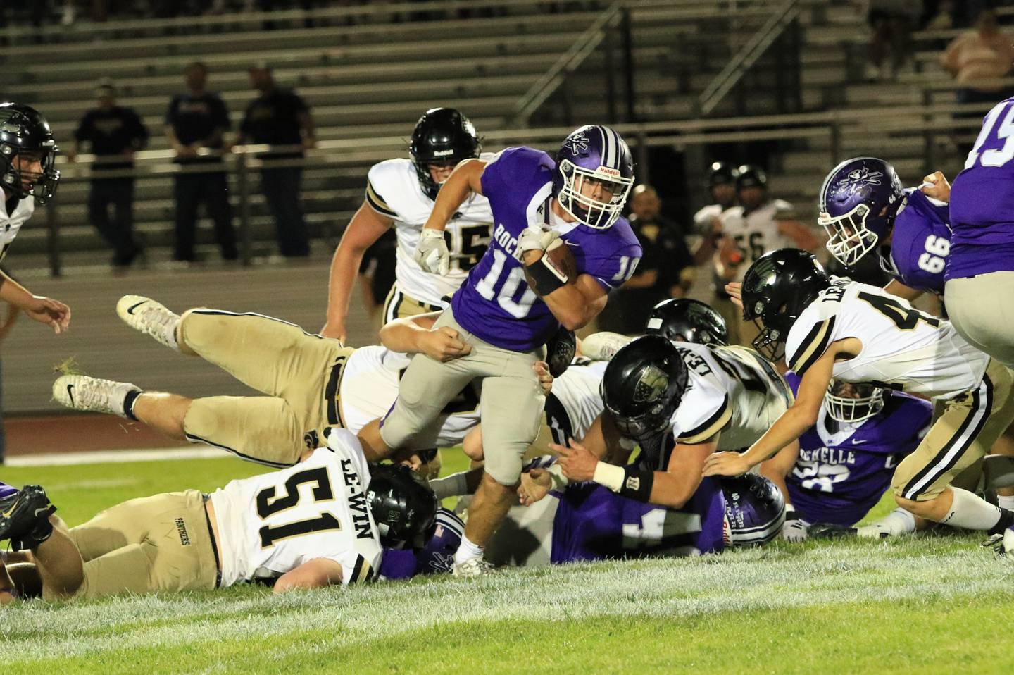 Rochelle's Dylan Manning (10) breaks a tackle during Friday's game with Lena-Winslow in Rochelle.