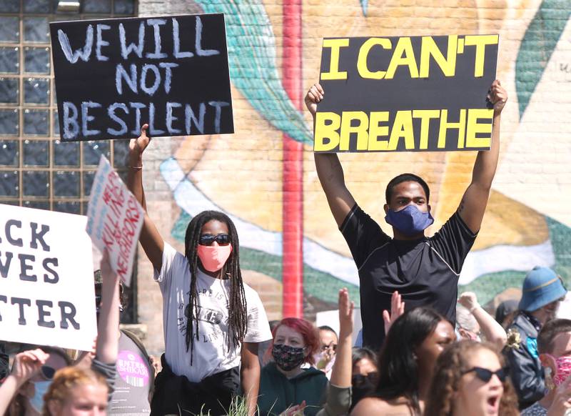 People chant and hold signs during a Black Lives Matter protest Saturday at the corner of First Street and Lincoln Highway in DeKalb. The protest drew hundreds of people who were angry about the recent deaths of Ahmaud Abrey, Breonna Taylor and George Floyd.