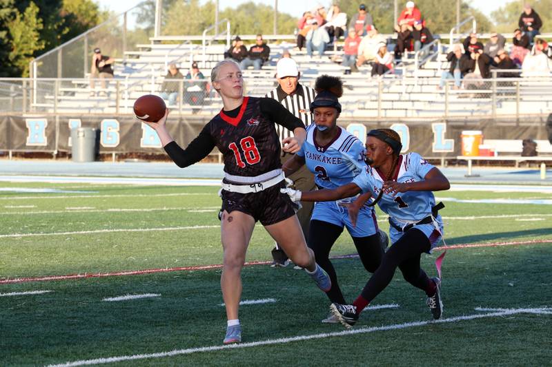 Yorkville's Brooke Ekwinski looks to pass as Kankakee's Essence Bell goes for the sack during the Foxes' 26-13 victory over Kankakee on Tuesday, Oct. 7, 2025.