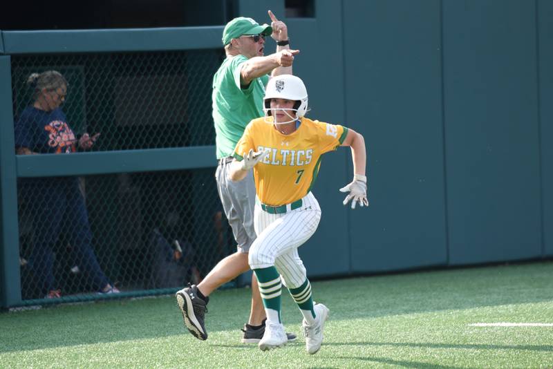 Providence's Bella Olszta (7) runs home in front of head coach James Holba during the Class 3A Illinois Wesleyan Supersectional against Pontiac Monday, June 9, 2025.