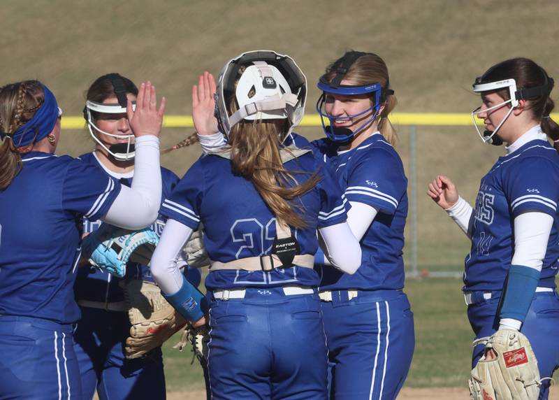 Members of the Princeton softball team hi-five in between innings while playing Ottawa on Friday, March 13, 2026 at Ottawa High School.