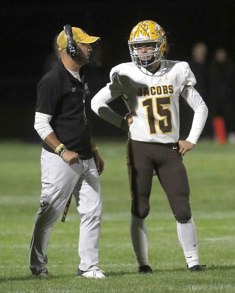 Jacobs Head Coach Brian Zimmerman talks with quarterback Austin Stennett during a Fox Valley Conference football game Prairie Ridge on Friday, Sept. 5, 2025, at Prairie Ridge High School in Crystal Lake.