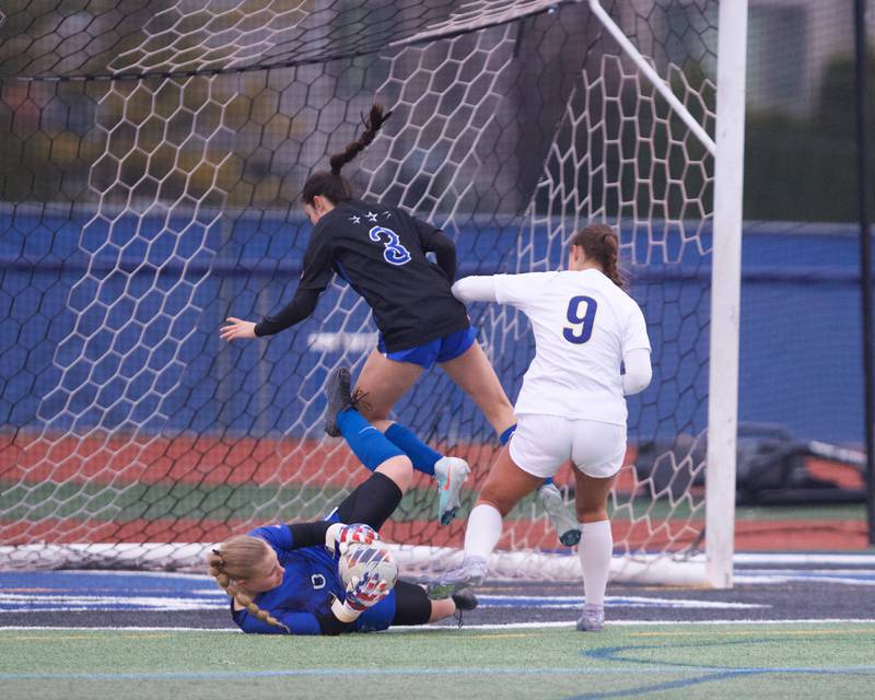 Wheaton North's Leah Roe makes the jumping catch against St. Charles North on Thursday, April 10,2025 in St. Charles.