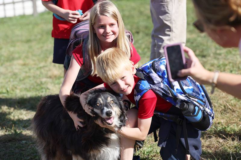 Elinor, 10 and Archer Pratt, 7, have their picture take with pooch Lilly Thursday, Oct. 3, 2024, at St. Mary’s School in Dixon.
