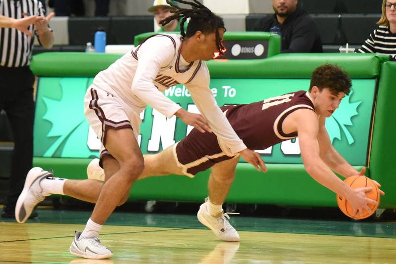 Morris' Brycen Johnson, right, dives for a loose ball as Kankakee's Kenaz Jackson follows closely during the IHSA Class 3A Geneseo Regional semifinals Thursday, Feb. 26, 2026.