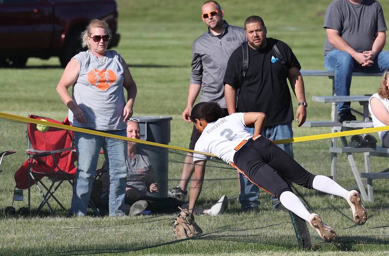 Freeport's Kennedy Kloeping tumbles over the fence as she tries to catch the home run hit by Sycamore's Kairi Lantz during their Class 3A regional championship game Friday, May 26, 2023, at Sycamore High School.