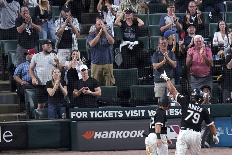 Chicago White Sox's Jose Abreu (79) points to the fans as he and Adam Eaton celebrate Abreu's two-run home run off St. Louis Cardinals starting pitcher Jack Flaherty during the fourth inning of a baseball game Tuesday, May 25, 2021, in Chicago. (AP Photo/Charles Rex Arbogast)