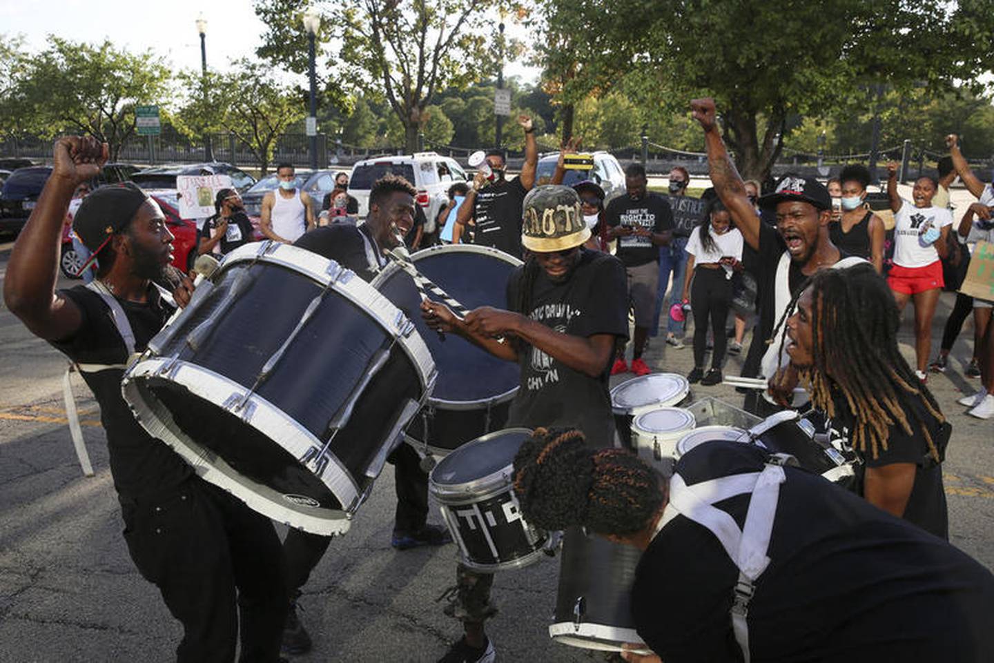 Demonstrators can be seen playing drums outside Joliet City Hall, the Will County Courthouse and the Joliet Police Department on Saturday, Aug. 22, 2020, in response to the January 28 overdose death of Eric Lurry who died in police custody.