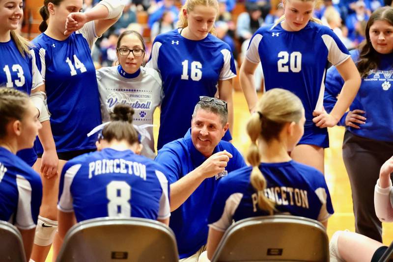 Longtime Princeton coach Andy Puck smiles in the huddle during Thursday's regional championship at Prouty Gym.