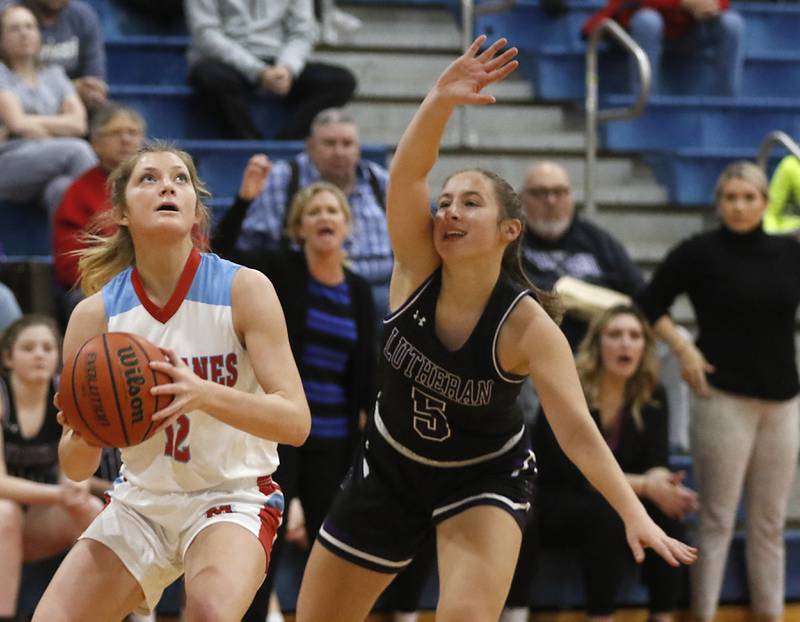Marian Central's Madison Kenyon drives to the basket against Rockford Lutheran's Addie Richard during a non-conference girls basketball game Monday, Dec. 12, 2022, between Marian Central and Rockford Lutheran at Marian Central Catholic High School, in Woodstock.