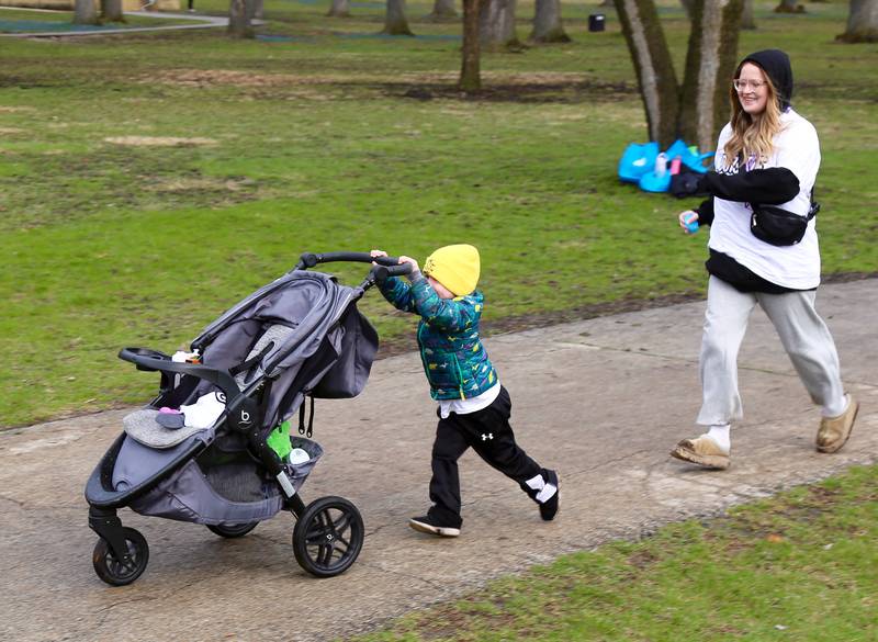 Three year old Oliver Meinen tries to run from Tiegan Przybyla at the Color Outside the Line 5K and Family Fair that was held in Geneva on April 5, 2025.