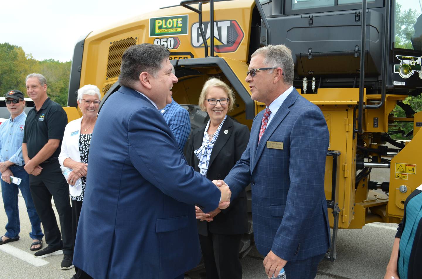 McHenry County Board chair Mike Buehler, right, shakes hands with Gov. JB Pritzker at the Longmeadow Parkway ribbon cutting in August 2024.