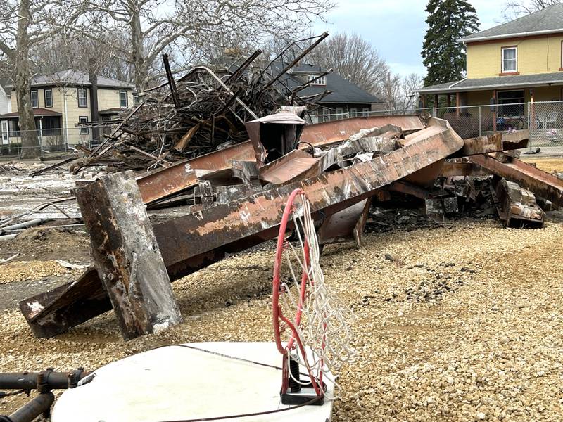A basketball backboard and hoop sits outside next to steel supports pulled from a section of the Congress School, 208 N. Congress Ave., on Friday, March 28, 2025 in Polo.. Demolition of the older, larger portion of the building has been tentatively set for Monday.