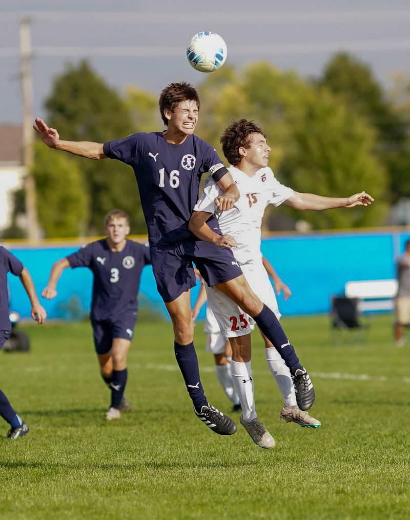 Oswego East's Mariano Ramirez (16) goes up for a header against Oswego’s Noah Abbas (25) during a soccer match at Oswego East High School on Tuesday, Sept. 26, 2023.