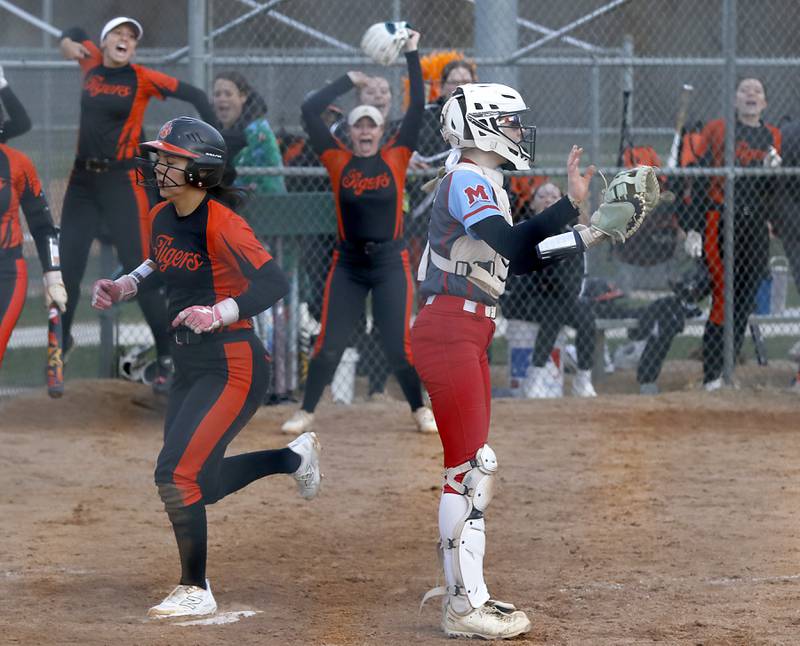 Crystal Lake Central's Ella Arana touches home plate behind Marian Central' catcher Bailey Keller in the eight inning to score the game winning run during a nonconference softball game against Marian Central on Thursday, April 3, 2025, at bates Park in Woodstock.