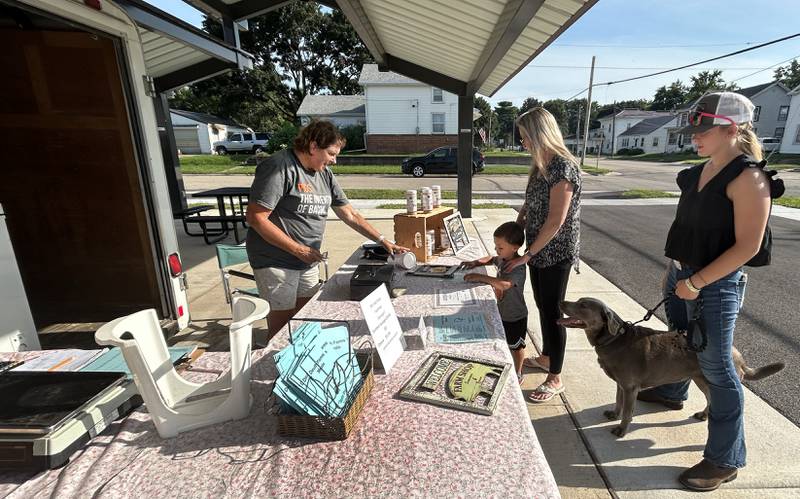 Jean Deuth waits on Kayla, Emma, and Archer Porter of Polo and their dog, Asher, at the Deuth Farms Meats booth during the Polo Farmer's Market on Thursday, Aug. 7, 2025. The market is held each Thursday from 3-6 p.m., weather permitting, at the Pavilion located on the southeast corner of South Division and Buffalo Street.