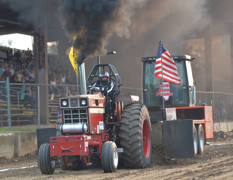 Joel Koch of Ladd drives his 1973 International Harvestor 1066 in the tractor pull at the Ogle County Fair on Thursday, July 31, 2025.