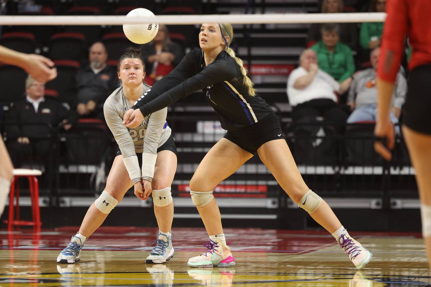 Newman’s Addison Foster (20) watches as teammate Jess Johns (6) gets the dig against Norris City-Omaha-Enfield in the Class 1A third-place match Saturday, Nov. 12, 2022, in Normal.