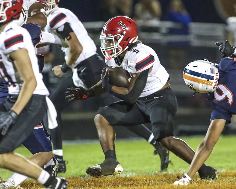 Yorkville's T.J. Harland (5) runs up the middle during football game between Yorkville at Oswego Friday, Sept 26, 2025 in Oswego.
