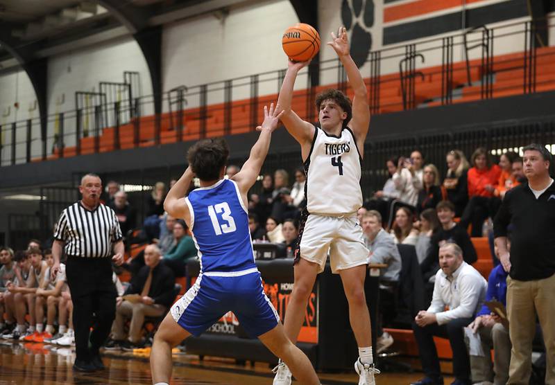Crystal Lake Central's Bud Shanahan shoots a three-pointer over Woodstock's Ryan Murray during a nonconference boys basketball game on Monday Jan. 5,  2026, at Crystal Lake Central School.