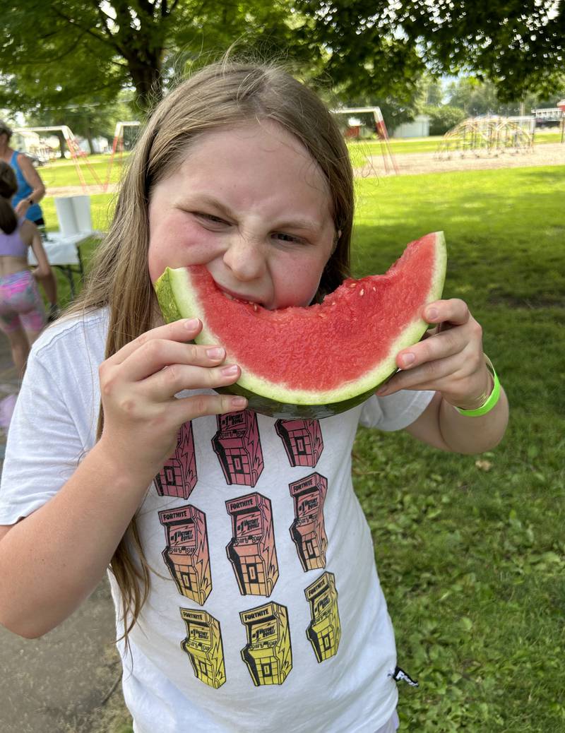 Rory Welch, 12, of Forreston, finishes off her slice of watermelon despite losing a tooth during the contest at Forreston's Sauerkraut Days' Watermelon Eating Contest on Saturday, Aug. 3, 2024.