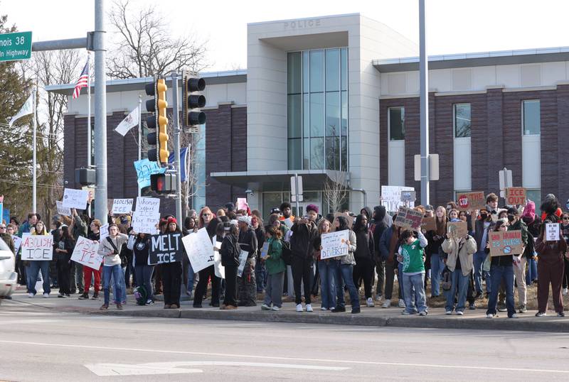 Northern Illinois University students hold signs and chant Friday, Feb 13, 2026, in front of the DeKalb Police Department, during a protest against recent nationwide U.S. Immigration and Customs Enforcement activity.