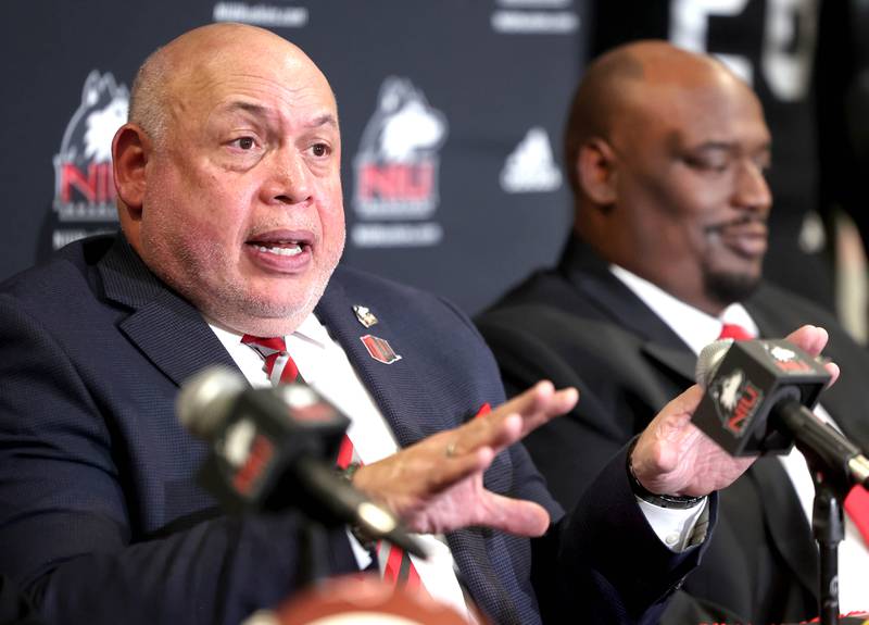 Northern Illinois University vice president and director of athletics and recreation Sean Frazier  (left) answers a question as head football coach Thomas Hammock looks on during a press conference Tuesday, Jan. 7, 2025, announcing that NIU football will be joining the Mountain West Conference starting with the 2026 season.