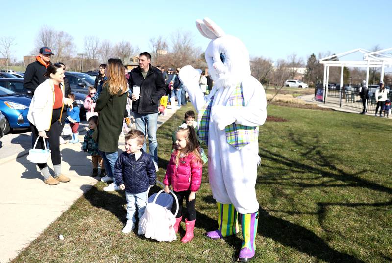 The Easter Bunny greets young participants during an egg hunt hosted by the Glen Ellyn Park District at Maryknoll Park on Friday, April 7, 2023.