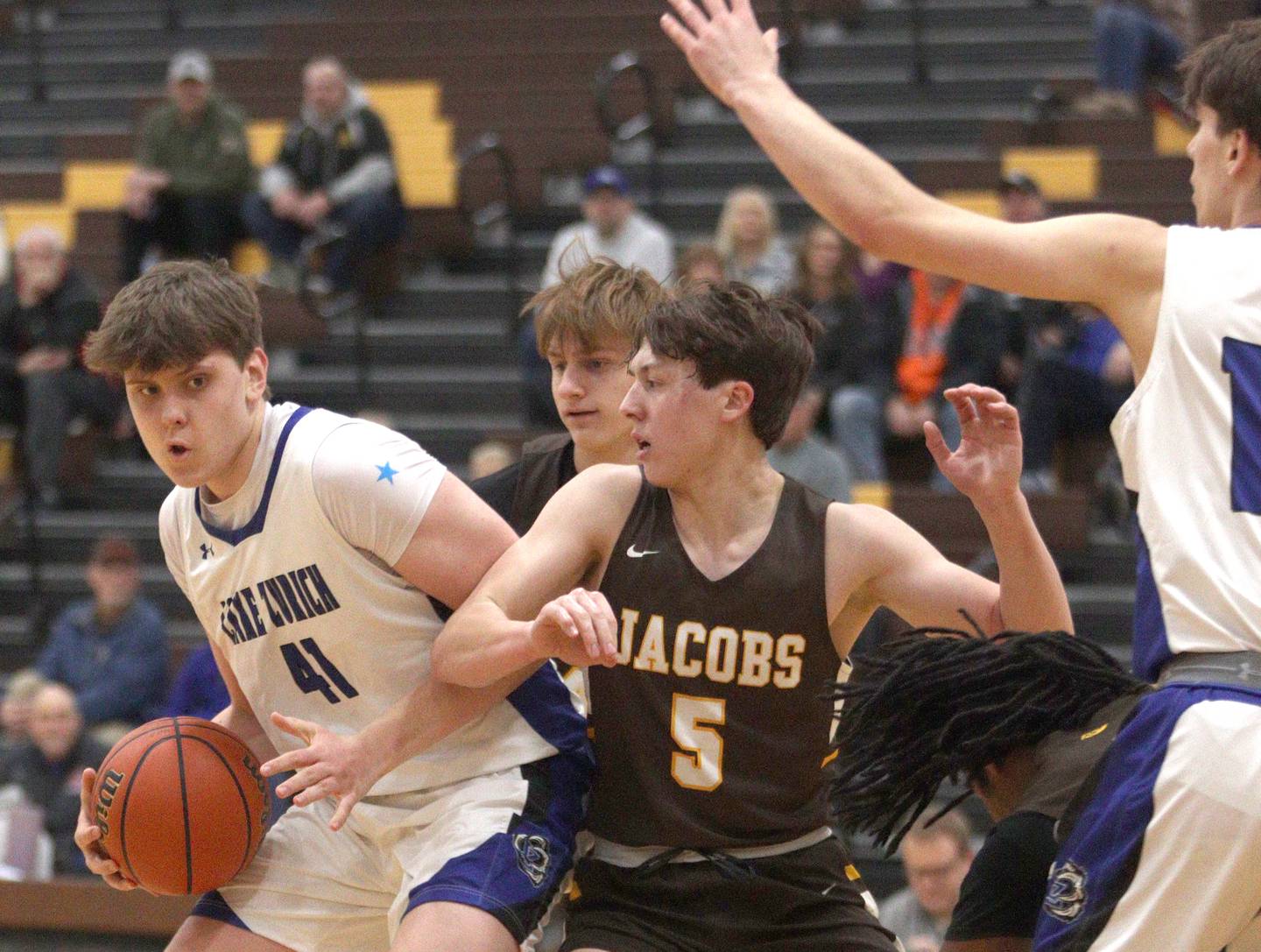 Jacobs’ Mark Takasaki (5) challenges Lake Zurich’s Anton Strelnikov in Hinkle Holiday Classic boys basketball tournament game action at Jacobs High School Tuesday.