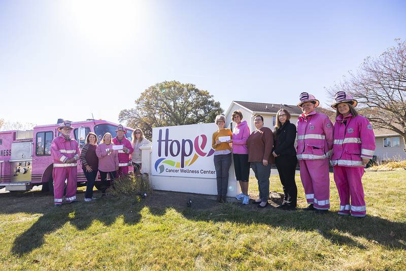 Birdies Fore Boobies, a charity golf outing, donated a pair of checks worth $14,000 to Hope Cancer Wellness Center and Pink Heals of the Sauk Valley on Thursday, Oct. 24. Pictured (from left) are Pink Heals' Barry Collinson; Mimi Boysen, secretary for Birdies Fore Boobies; Monica Hendricks, president of B4B; Pink Heals Director Brian Tribley; Jennifer Lange, B4B committee member; Hope Cancer Wellness Center Director Joan Padilla; Sonja Nicklaus; Tori McDaniel; Adreanna Sommer; and Pink Heals' Harry Vroman and Elizabeth Tribley. Not pictured are B4B committee members Patty Oliver, Julie Helfrich, Jennifer Westphal, Mandy Hinkey and Sheryl Gulbranson.