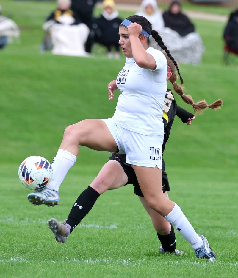 Kaneland's Adriana Warrington kicks the ball away from Sycamore's Cortni Kruizenga during their game Wednesday, April 29, 2026, at Sycamore High School.