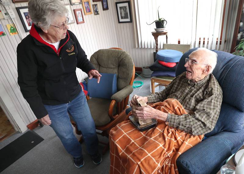 Colette Theurer, a driver with the Voluntary Action Center, chats with 102-year-old Wilbur Kocher after delivering his meal, Thursday, Nov. 17, 2022, at his home in Sycamore. VAC delivers meals to the homebound and elderly along with providing transportation options.