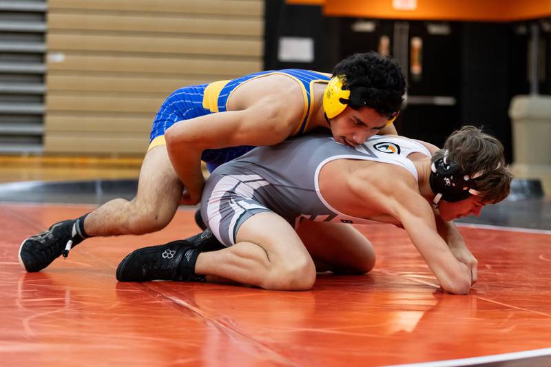 Joliet Central's Isaiah Kan takes on Nick Polzin of Plainfield East in the 144-pound match at Plainfield East on Dec. 12, 2024.