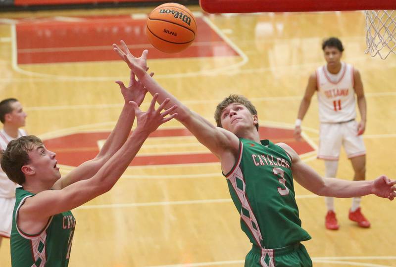 L-P's Jameson Hill and Braylin Bond jump for a rebound against Ottawa on Friday, Feb. 6, 2026 in Kingman Gymnasium at Ottawa High School.