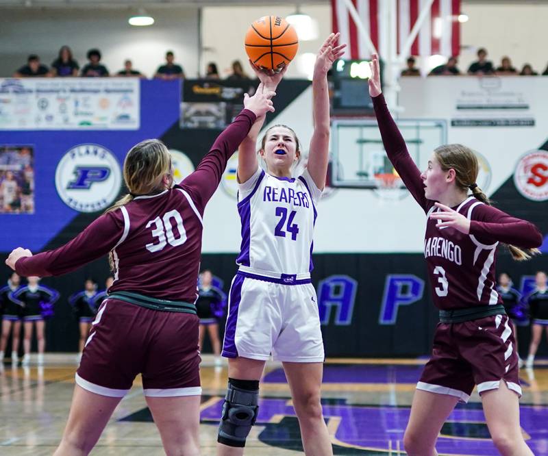 Plano's Chloe Rowe (24) shoots the ball in the post against Marengo’s Macy Noe (30) and Maggie Hanson (3) during a basketball game at Plano High School on Wednesday, January 29, 2025.