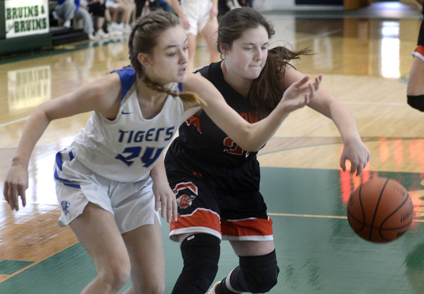 Princeton’s Keighley Davis (left) and Sandwich’s Lily Geltz reach for a loose ball during the first quarter Tuesday at St Bede.