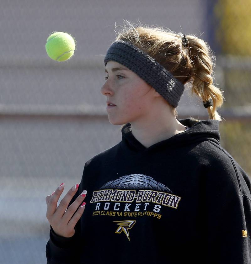 Richmond-Burton’s Savannah Webb flips the tennis ball in the air between points Thursday, Oct. 20, 2022, during during the first day of the IHSA State Girls Tennis Tournament at Hoffman Estates High School in Hoffman Estates.