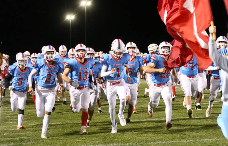 Members of the Ottawa football team run onto the field on Friday, Oct. 24, 2025 on Kingman Field at Ottawa High School.