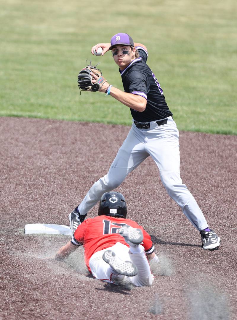 Downers Grove North's Ean Czech (22) starts a double play as Hinsdale Central's Benjamin Oosterbaan (12) slides into second during the IHSA Class 4A baseball regional final between Downers Grove North and Hinsdale Central at Bolingbrook High School on Saturday, May 27, 2023.